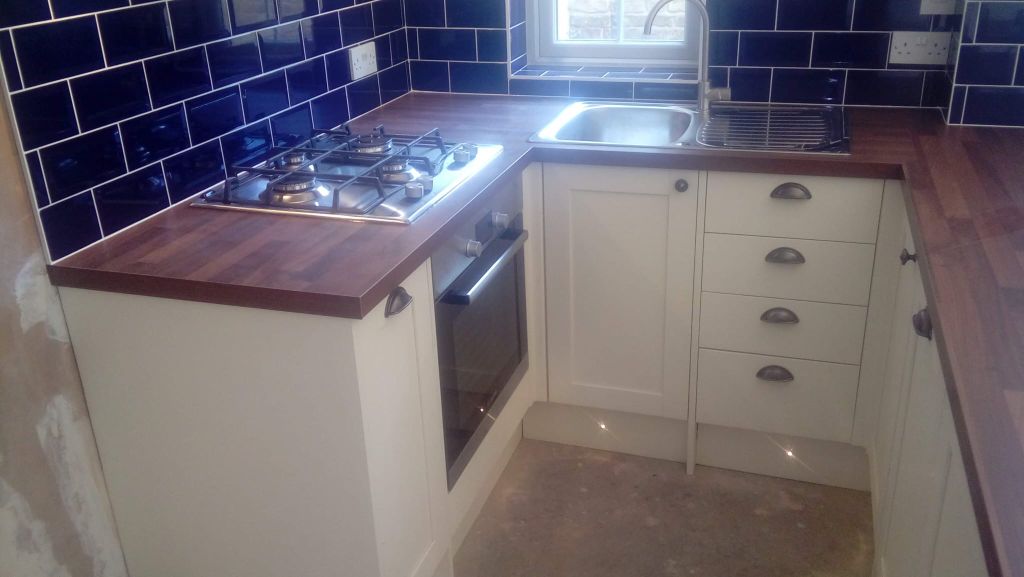 Cream shaker kitchen with navy metro tiles