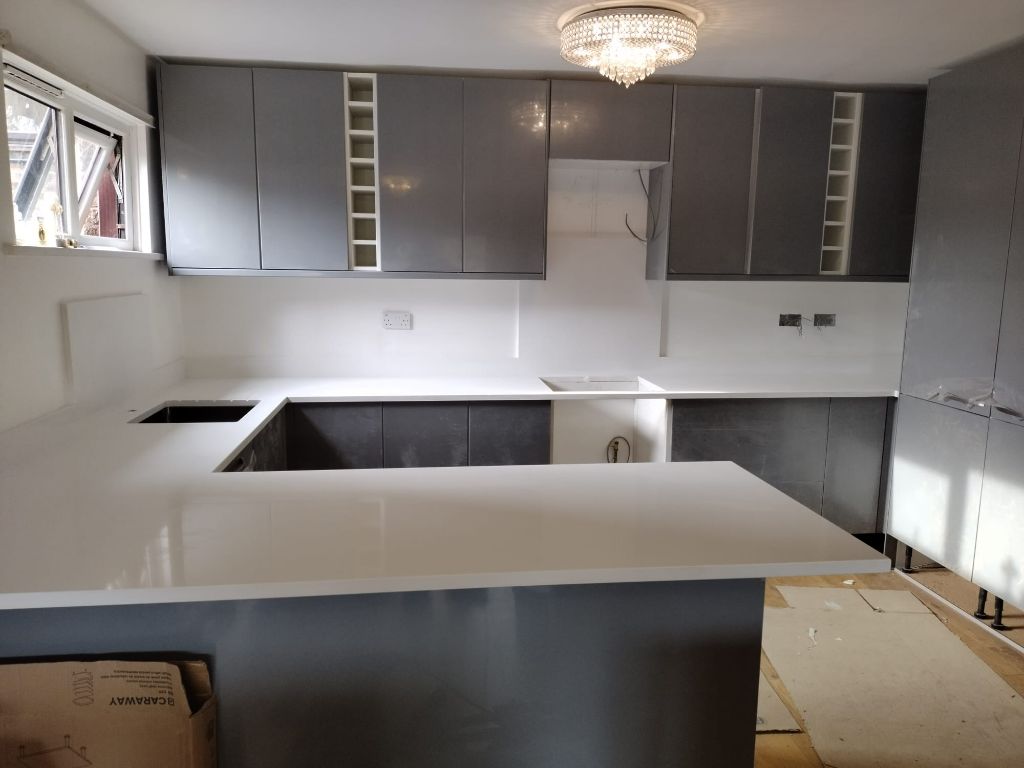 Grey gloss fitted kitchen with quartz island